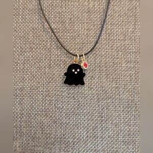Black Ghost Pendant Necklace With A Red Crystal Charm On A Black Cord